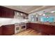 Gourmet kitchen features a Wolf range, stone countertops, custom cabinets, and modern stainless steel hood at 1891 Curtis St # 1613, Denver, CO 80202