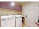 Functional laundry room with modern washer, dryer, and cabinet storage at 1891 Curtis St # 1613, Denver, CO 80202