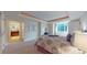 Luxurious main bedroom with carpet, tray ceiling, and a glimpse into an ensuite bath at 1891 Curtis St # 1613, Denver, CO 80202
