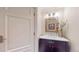 Chic powder room features a dark wood vanity, stone countertop and decorative mirror at 1891 Curtis St # 1613, Denver, CO 80202