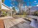 Large backyard with a spacious deck, mature trees, and bench seating at 3790 E Geddes Ave, Centennial, CO 80122