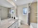 Bright bathroom with granite countertop vanity, large mirror, tile flooring, and shower-tub combo at 3790 E Geddes Ave, Centennial, CO 80122