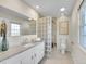 Bright bathroom featuring a glass block shower, modern vanity, and tile flooring at 3790 E Geddes Ave, Centennial, CO 80122