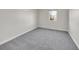 Carpeted bedroom with a window, offering a simple and neutral space at 3790 E Geddes Ave, Centennial, CO 80122