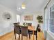 Elegant dining room with hardwood floors, wainscoting, and a large window for natural light at 3790 E Geddes Ave, Centennial, CO 80122