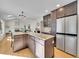 Open kitchen with an island, stainless appliances, granite counters, and hardwood floors at 3790 E Geddes Ave, Centennial, CO 80122