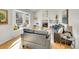 Bright living room with a fireplace, modern furniture, large windows, and decorative built-in shelves at 3790 E Geddes Ave, Centennial, CO 80122