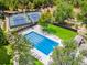 Aerial view of community pool and tennis courts surrounded by lush greenery, offering recreation opportunities at 3790 E Geddes Ave, Centennial, CO 80122