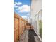 Exterior backyard view with a tall wood fence, small fenced-in yard, and glass sliding door at 5375 W 14Th Ave, Lakewood, CO 80214