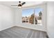 Bedroom with ceiling fan, neutral carpet, and a large window overlooking the neighborhood at 5375 W 14Th Ave, Lakewood, CO 80214