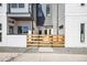 Modern townhomes boast gray and white siding, and inviting front patios enclosed by wood fencing at 5375 W 14Th Ave, Lakewood, CO 80214