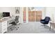 Modern home office with a large window, desk setup, and stylish blue accent chair at 5375 W 14Th Ave, Lakewood, CO 80214