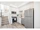 This kitchen boasts stainless steel appliances, white cabinets, and modern fixtures at 5375 W 14Th Ave, Lakewood, CO 80214