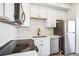 Close up shot of kitchen with stainless steel appliances, white countertops, and a black faucet at 5375 W 14Th Ave, Lakewood, CO 80214