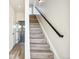 Open staircase with modern railing and light-toned wood steps, creating a seamless transition between floors at 5375 W 14Th Ave, Lakewood, CO 80214