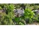 Aerial view of a home with lush backyard, fire pit, playset, and mature trees on a sunny day at 15 South Ln, Cherry Hills Village, CO 80113