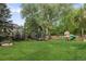 Spacious backyard featuring a trampoline and playset, perfect for Gathering fun and outdoor activities at 15 South Ln, Cherry Hills Village, CO 80113