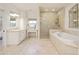 Luxurious bathroom with a soaking tub, glass shower, and double vanity sinks at 15 South Ln, Cherry Hills Village, CO 80113