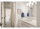 Well-lit bathroom featuring a white vanity, chrome fixtures, and a shower with white tile at 15 South Ln, Cherry Hills Village, CO 80113