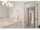 Bright bathroom with white vanity, chrome fixtures, and an open view to a shower room beyond at 15 South Ln, Cherry Hills Village, CO 80113