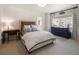 Comfortable bedroom with a neutral color palette, desk, and large window providing natural light at 15 South Ln, Cherry Hills Village, CO 80113