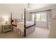 Bright bedroom boasts a four poster bed, neutral walls, and a large window overlooking the outdoors at 15 South Ln, Cherry Hills Village, CO 80113