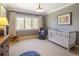 Cozy Bedroom featuring gray wallpaper, a white crib, and a comfortable sitting area at 15 South Ln, Cherry Hills Village, CO 80113