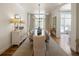 Elegant dining room with large windows, hardwood floors, and a chandelier over a long dining table at 15 South Ln, Cherry Hills Village, CO 80113