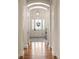 Elegant entryway featuring hardwood floors, arched doorways, and a stylish front door with sidelights at 15 South Ln, Cherry Hills Village, CO 80113