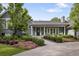 Charming two-story home with a well-manicured lawn and mature trees on a sunny day at 15 South Ln, Cherry Hills Village, CO 80113