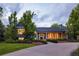 Charming two-story home with a well-manicured lawn and mature trees, bathed in the soft glow of twilight at 15 South Ln, Cherry Hills Village, CO 80113