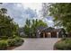 Spacious three-car garage with a basketball hoop, set amidst lush landscaping and a circular driveway at 15 South Ln, Cherry Hills Village, CO 80113