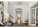 Elegant hallway with arched doorways, hardwood floors, and stylish lighting fixtures at 15 South Ln, Cherry Hills Village, CO 80113