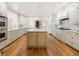 Bright kitchen featuring white cabinetry, a butcher block island, and stainless steel appliances at 15 South Ln, Cherry Hills Village, CO 80113