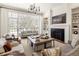 Elegant living room with large windows, a fireplace, and built-in shelving, creating a cozy atmosphere at 15 South Ln, Cherry Hills Village, CO 80113