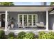 Inviting front porch with comfortable seating, a porch swing, and stylish decor for relaxing outdoors at 15 South Ln, Cherry Hills Village, CO 80113