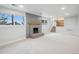 Spacious finished basement featuring a brick fireplace and access to the upper levels at 9435 Osceola St, Westminster, CO 80031