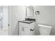 Updated bathroom features a black faucet, white cabinets and a modern mirror at 9435 Osceola St, Westminster, CO 80031