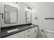 Elegant bathroom featuring a double vanity with black countertop and modern fixtures at 9435 Osceola St, Westminster, CO 80031