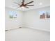Large bedroom features neutral carpet, a ceiling fan, and natural light from two windows at 9435 Osceola St, Westminster, CO 80031