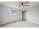 Bright bedroom featuring gray carpet, with a tree view from the window at 9435 Osceola St, Westminster, CO 80031