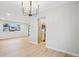 Open dining area featuring a modern light fixture, views of the kitchen and front yard at 9435 Osceola St, Westminster, CO 80031