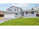 Charming two-story home with lush green lawn and an attached garage at 9435 Osceola St, Westminster, CO 80031