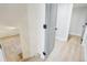 Hallway featuring carpeted stairs and hardwood floors at 9435 Osceola St, Westminster, CO 80031