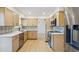 Bright kitchen with stainless steel appliances, modern cabinetry and a beautiful backsplash design at 9435 Osceola St, Westminster, CO 80031