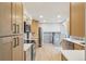 Modern kitchen with stainless steel appliances, ample storage, and easy access to other living areas at 9435 Osceola St, Westminster, CO 80031