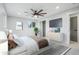 Serene main bedroom with large window, ceiling fan, and a stylish dresser with a TV at 9435 Osceola St, Westminster, CO 80031