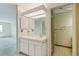 Bathroom vanity with sink, mirror, and lighting; door to toilet area at 14390 E Marina Dr # 601, Aurora, CO 80014