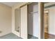 Bedroom featuring closet with mirrored sliding doors and access to bathroom at 14390 E Marina Dr # 601, Aurora, CO 80014