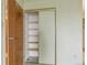 Open closet with sliding doors and shelving for organization in bedroom at 14390 E Marina Dr # 601, Aurora, CO 80014